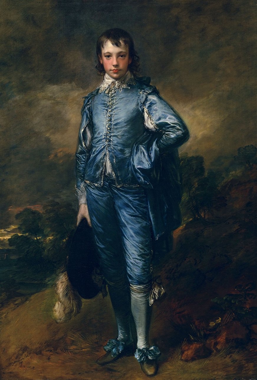 A young gentleman in shimmering blue Van Dyck dress stands in a brown landscape